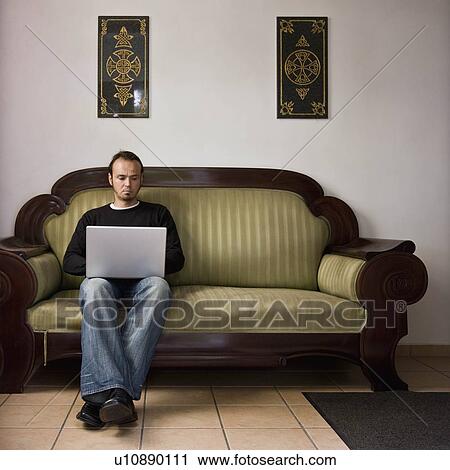 Man working on a laptop computer View Large Photo Image Stock Image - Man working on a laptop computer. Fotosearch