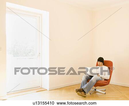 Stock Image - Man working on a laptop computer. Fotosearch