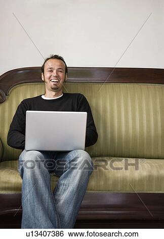 Man working on a laptop computer View Large Photo Image Stock Photograph - Man working on a laptop computer. Fotosearch