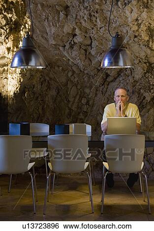 Man working on a laptop computer View Large Photo Image Stock Photograph - Man working on a laptop computer. Fotosearch