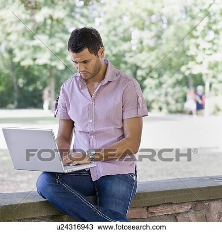 Man working on laptop computer View Large Photo Image Stock Image - Man working on laptop computer. Fotosearch