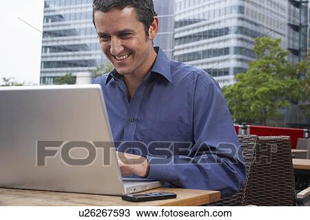Man working on laptop outside View Large Photo Image Stock Image - Man working on laptop outside. Fotosearch