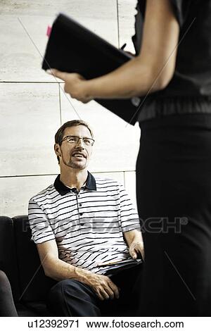 Man working with a woman View Large Photo Image Stock Image - Man working with a woman. Fotosearch