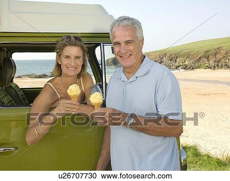 Stock Image - Mature couple eating ice cream. Fotosearch