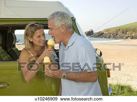 Stock Photo - Mature couple eating ice cream. Fotosearch