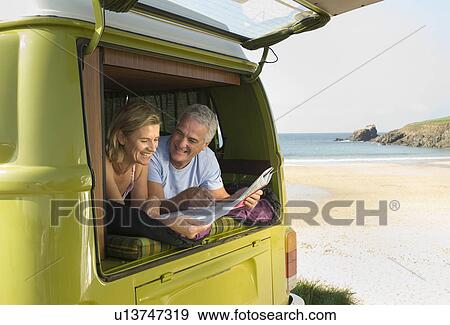 Mature couple lying in camper van View Large Photo Image Stock Photo - Mature couple lying in camper van. Fotosearch