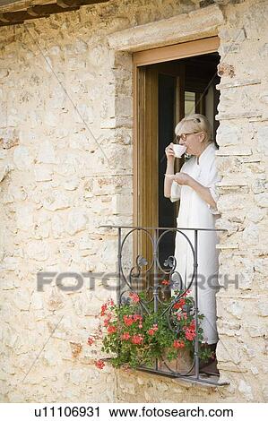 Stock Image - Mature woman drinking coffee. Fotosearch
