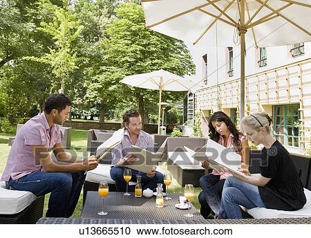 Men and women talking over menus View Large Photo Image Stock Image - Men and women talking over menus. Fotosearch