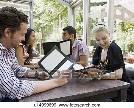 Men and women talking over menus View Large Photo Image Stock Photo - Men and women talking over menus. Fotosearch