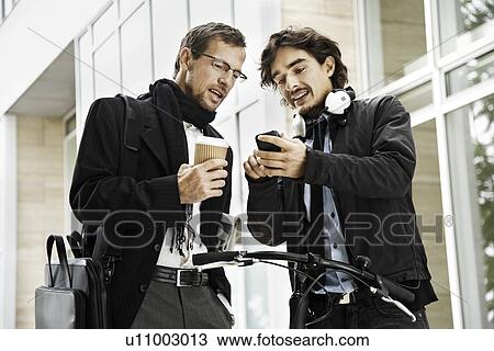 Stock Image - Men next to bicycle, coffee break. Fotosearch