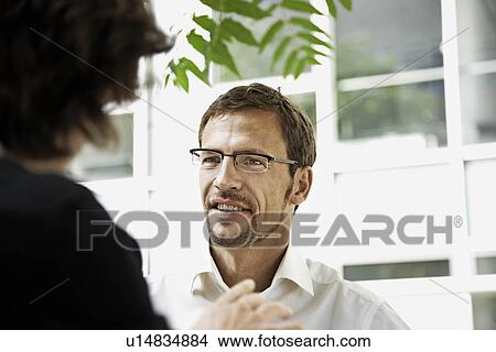 Picture - Men talking, outside. Fotosearch