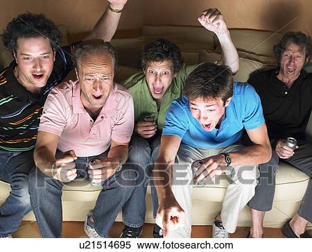 Stock Photography - Men watching television, holding beers. Fotosearch