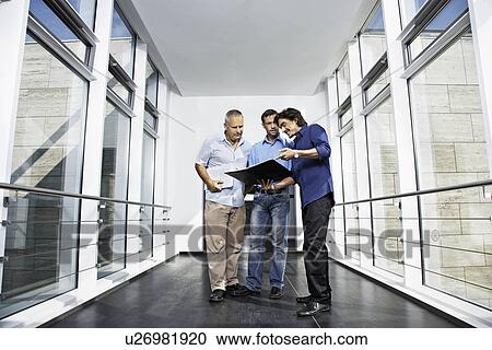 Stock Image - Men working on a project. Fotosearch