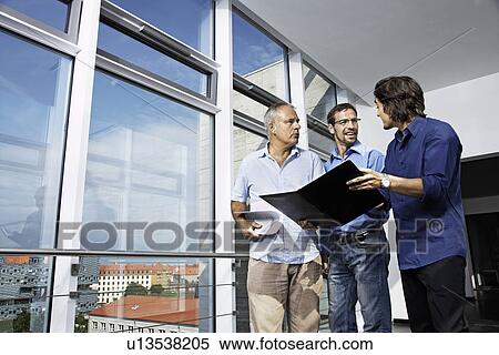 Stock Photography - Men working on a project. Fotosearch