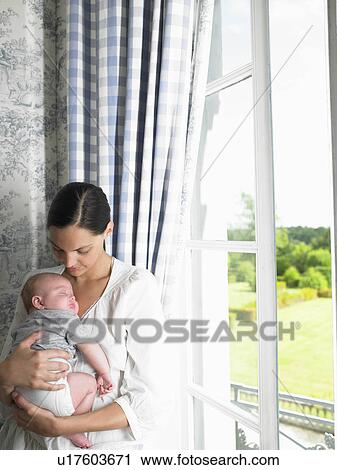 Stock Image - Mother and baby by the window. Fotosearch