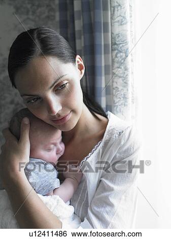 Stock Photograph - Mother and baby by the window. Fotosearch