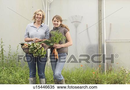 Stock Photography - Mother And Daughter With Vegetables. Fotosearch