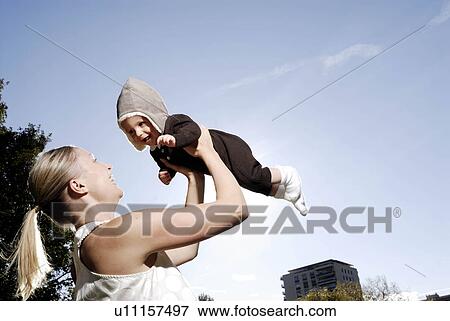Mother holding baby View Large Photo Image Stock Photo - Mother holding baby. Fotosearch