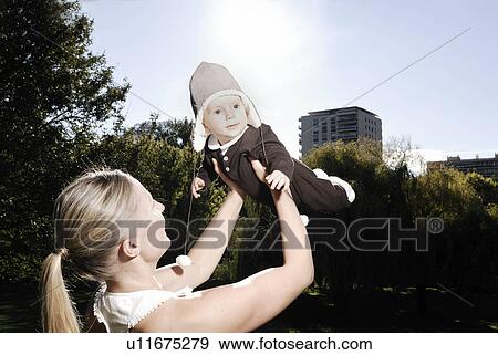 Mother holding baby View Large Photo Image Stock Photo - Mother holding baby. Fotosearch