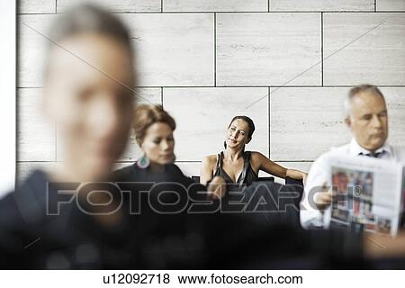 Stock Photo - People in a waiting room. Fotosearch