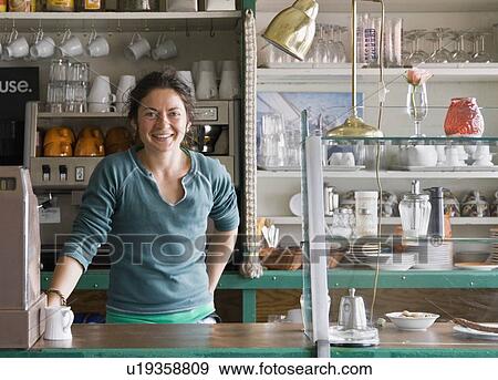 Stock Photo - Portrait of a female barista at a cafe. Fotosearch
