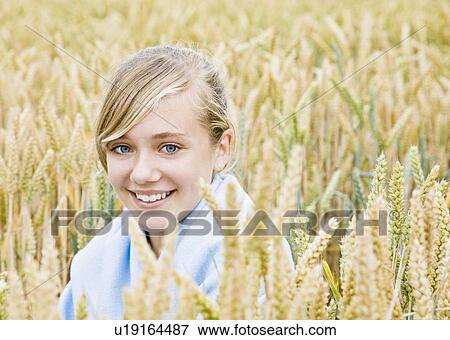 Portrait of a girl in a field View Large Photo Image Stock Photo - Portrait of a girl in a field. Fotosearch