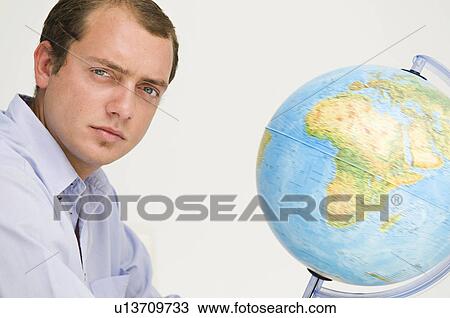 Stock Image - Portrait of a male and a globe. Fotosearch