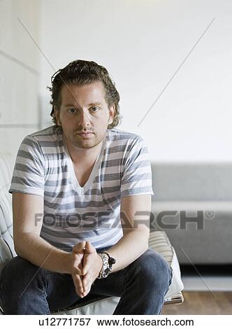 Portrait of a man in a living room View Large Photo Image Stock Photo - Portrait of a man in a living room. Fotosearch