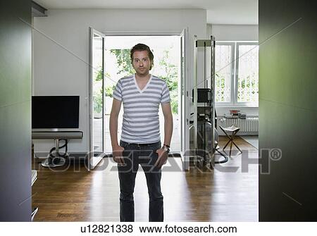 Portrait of a man in a living room View Large Photo Image Stock Photo - Portrait of a man in a living room. Fotosearch