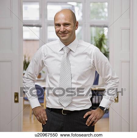 Stock Image - Portrait of a man in his office. Fotosearch