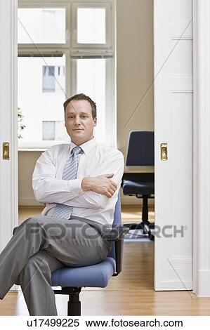 Portrait of a man in his office View Large Photo Image Stock Photography - Portrait of a man in his office. Fotosearch