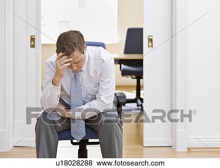 Stock Photo - Portrait of a man in his office worried. Fotosearch