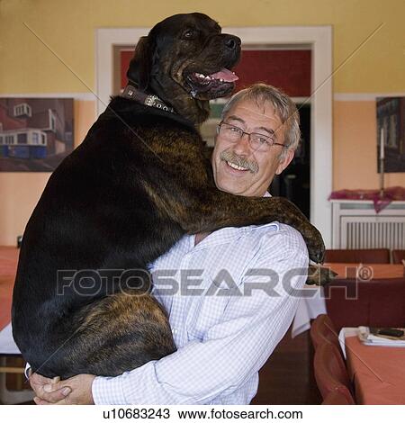 Stock Image - Portrait of a man with his dog. Fotosearch