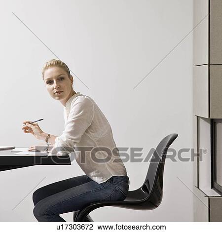 Stock Image - Portrait of a woman doing bills. Fotosearch