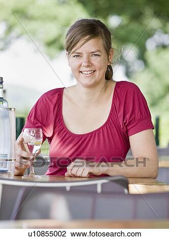 Stock Image - Portrait of a woman drinking wine. Fotosearch