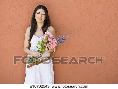 Stock Image - Portrait of a woman with flowers. Fotosearch