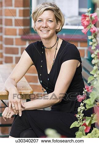 Stock Photo - Portrait of a women sitting at a cafe. Fotosearch