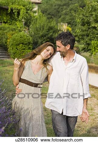 Portrait of couple walking in garden View Large Photo Image Stock Photograph - Portrait of couple walking in garden. Fotosearch