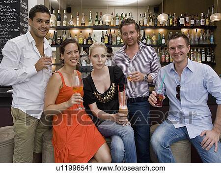 Portrait of friends at bar drinking View Large Photo Image Stock Image - Portrait of friends at bar drinking. Fotosearch
