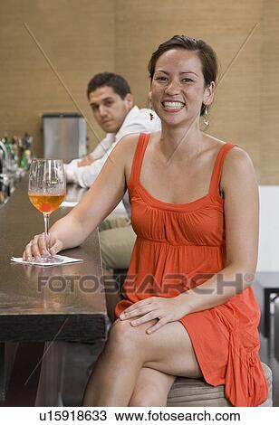 Stock Image - Portrait of girl sitting at bar. Fotosearch