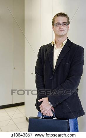 Portrait of man holding briefcase View Large Photo Image Stock Photo - Portrait of man holding briefcase. Fotosearch