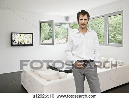 Portrait of man in living room View Large Photo Image Stock Image - Portrait of man in living room. Fotosearch