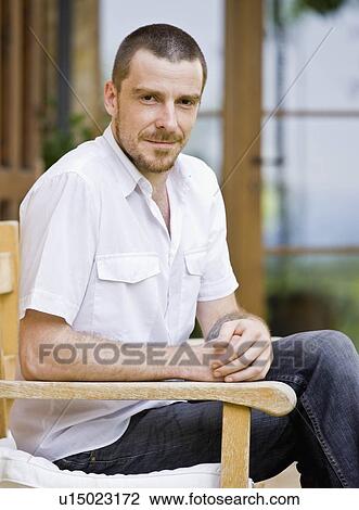 Portrait of man relaxing in a garden View Large Photo Image Stock Image - Portrait of man relaxing in a garden. Fotosearch