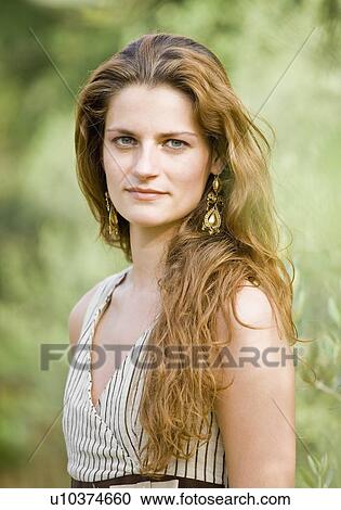 Stock Image - Portrait of woman in olive grove. Fotosearch