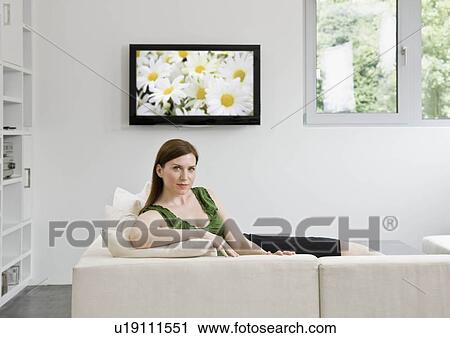 Portrait of woman laying on couch View Large Photo Image Stock Image - Portrait of woman laying on couch. Fotosearch