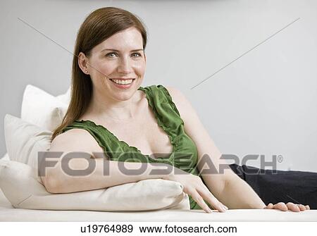 Portrait of woman laying on couch View Large Photo Image Stock Photo - Portrait of woman laying on couch. Fotosearch