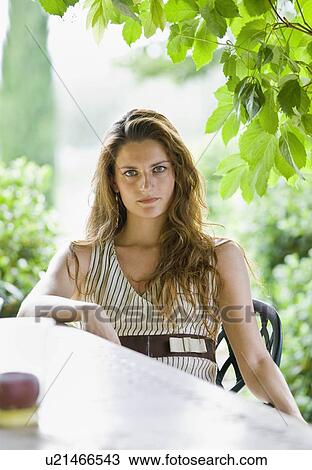Portrait of woman relaxing in a garden View Large Photo Image Stock Image - Portrait of woman relaxing in a garden. Fotosearch