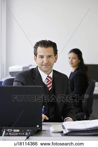 Portrait of workers in busy office View Large Photo Image Stock Photograph - Portrait of workers in busy office. Fotosearch