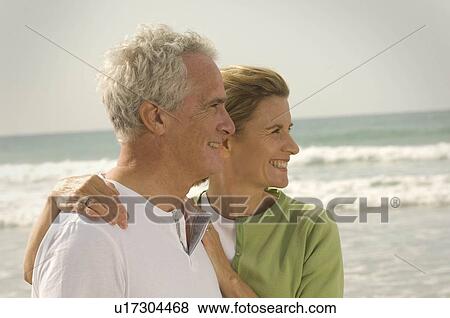 Profile portrait of couple on a beach View Large Photo Image Stock Photo - Profile portrait of couple on a beach. Fotosearch