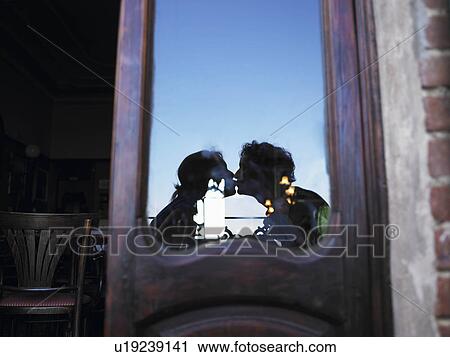 Reflection of couple kissing in café. View Large Photo Image Stock Image - Reflection of couple kissing in café.. Fotosearch